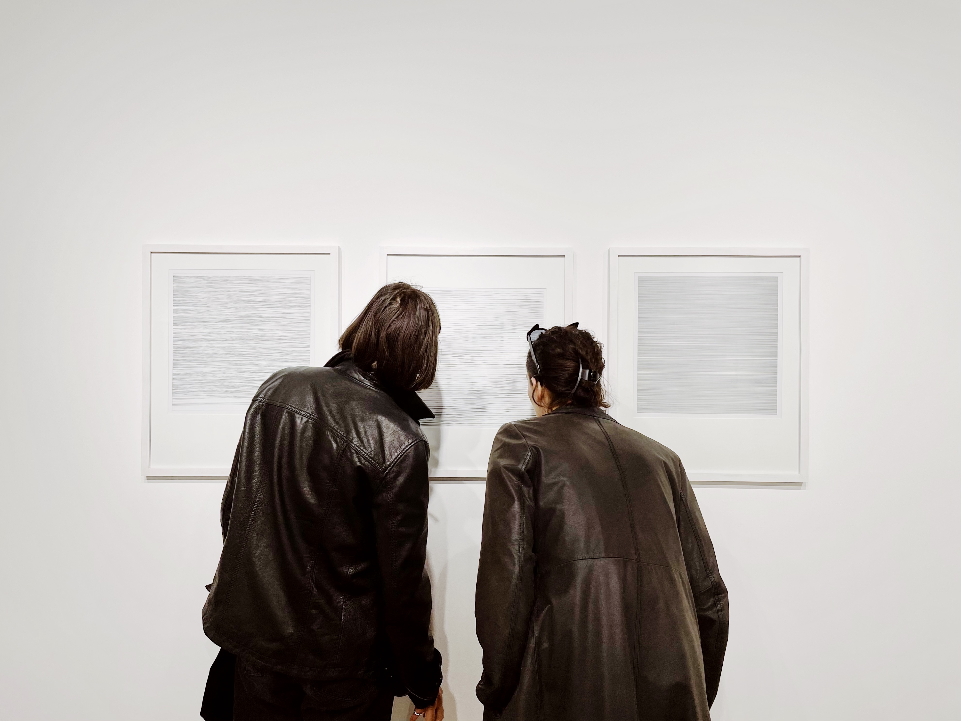 Operator visiting Hans Dehlinger's first solo show PLOTTED LINES at EXPANDED.ART in Berlin, 2023.