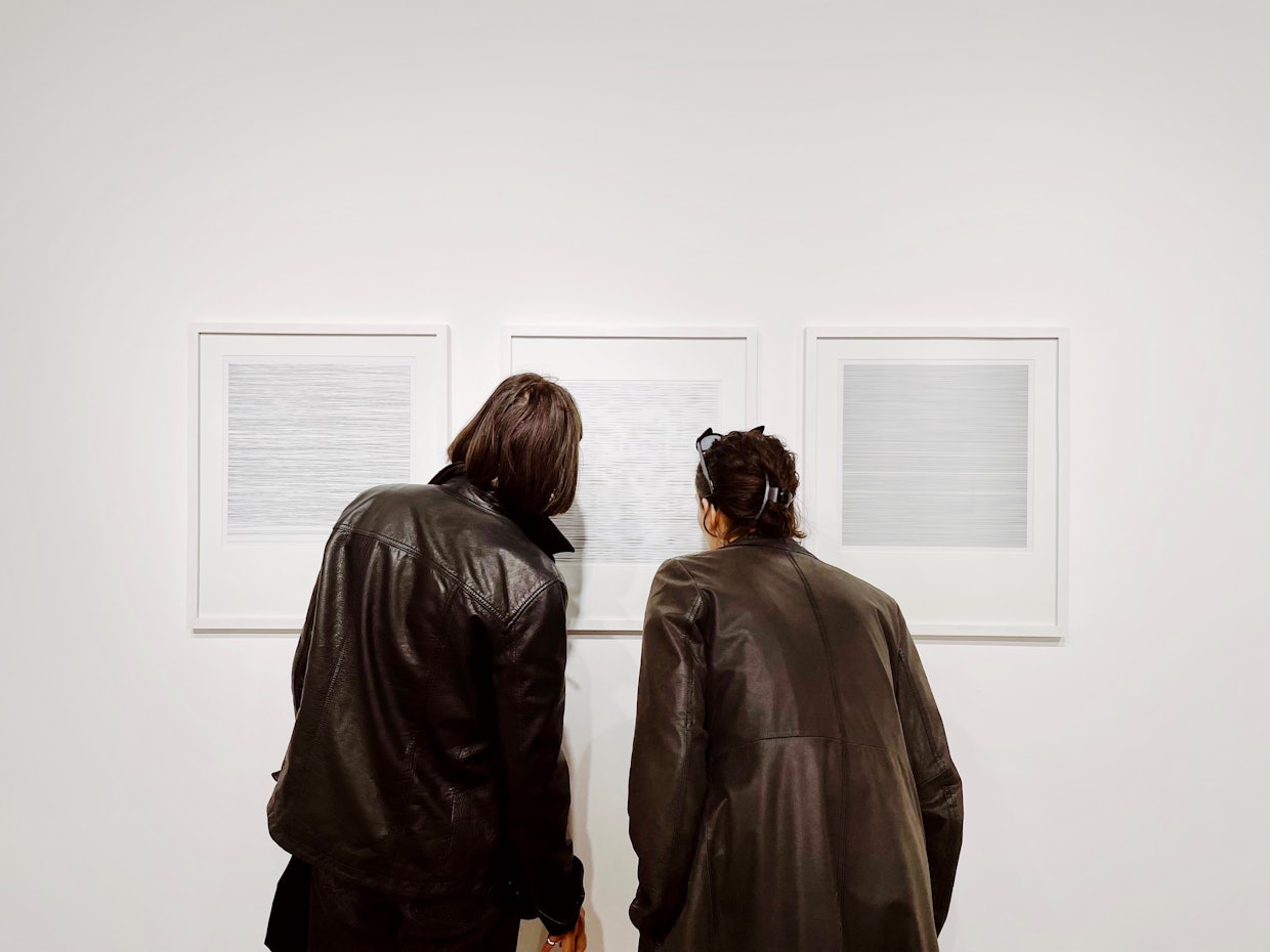 Operator visiting Hans Dehlinger's first solo show PLOTTED LINES at EXPANDED.ART in Berlin, 2023.